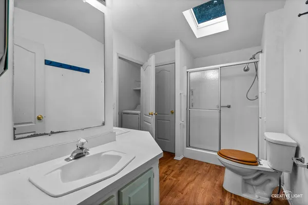 a bathroom with a sink a toilet and shower