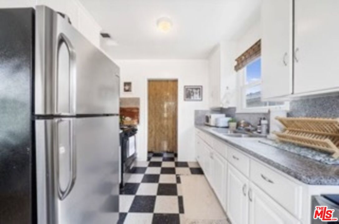 247 3rd Avenue Venice, CA 90291 - Photo 7 of 12 a kitchen with stainless steel appliances granite countertop a refrigerator and a sink