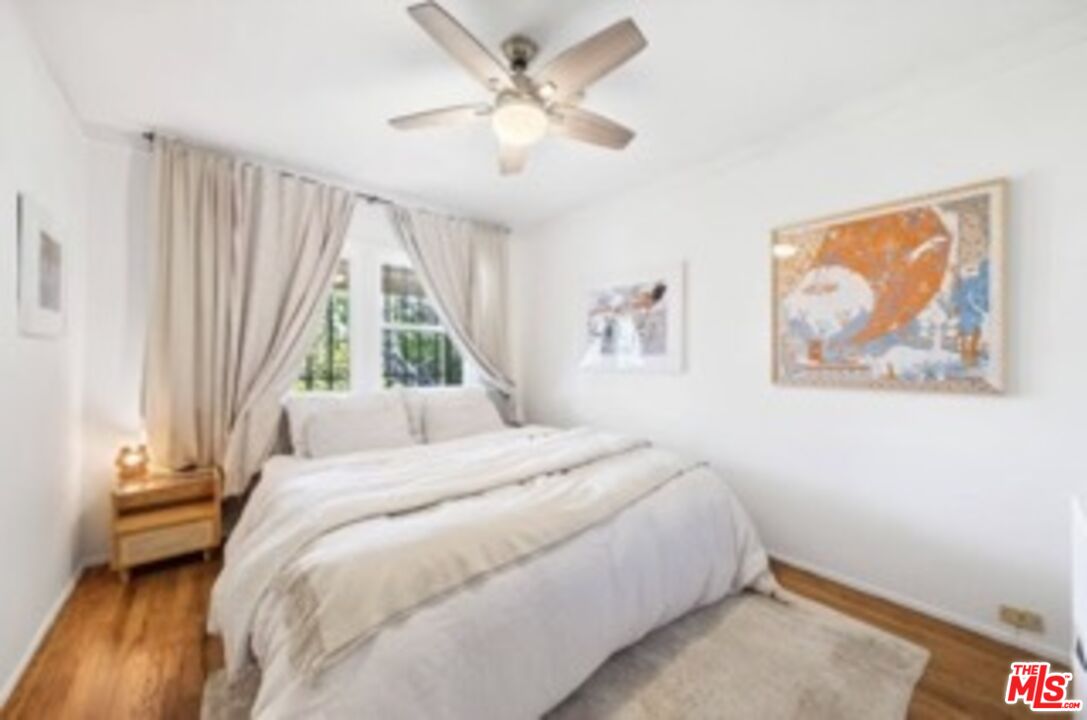 247 3rd Avenue Venice, CA 90291 - Photo 8 of 12 a bedroom with a bed and a painting on the wall