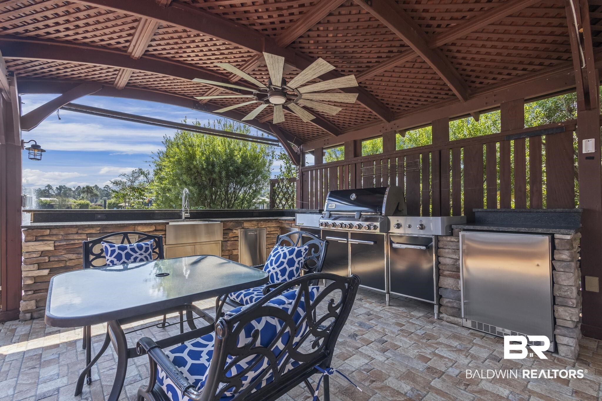 212 Magnifico Drive Foley, AL 36535 - Photo 9 of 50 View of patio with area for grilling, ceiling fan, and sink