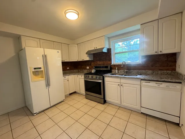 a kitchen with granite countertop cabinets and steel stainless steel appliances