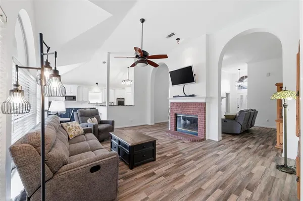 a living room with furniture a fireplace and a flat screen tv