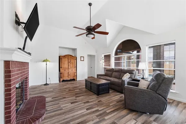 a living room with furniture a ceiling fan and a rug