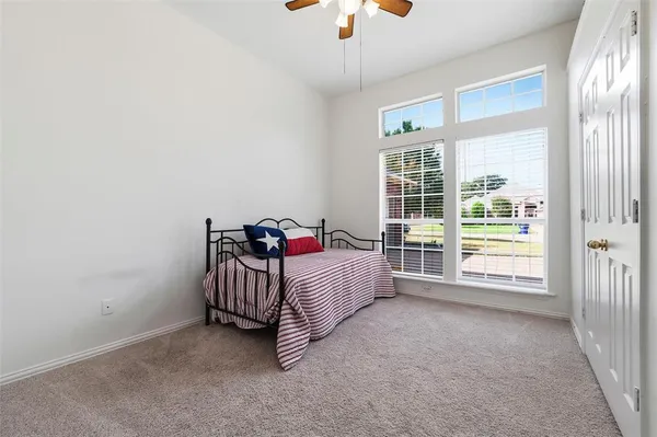 a bed room with a bed and a chair