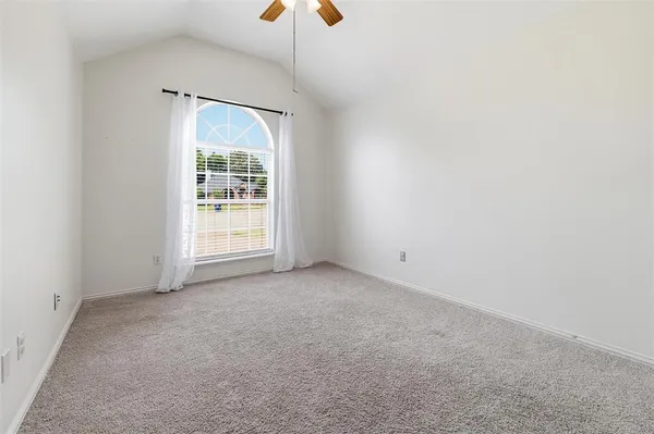 an empty room with windows and entrance