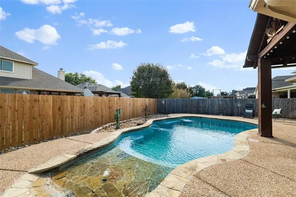 a view of a backyard with swimming pool