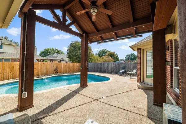 a view of a porch with wooden floor and wooden fence