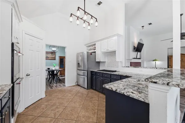 a kitchen with a stove and a refrigerator