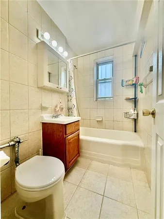 a bathroom with a sink a toilet and bathtub