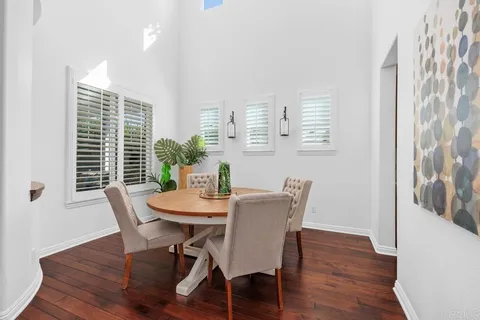 a living room with furniture a fireplace and a floor to ceiling window