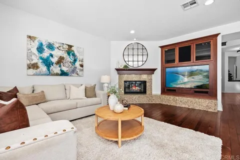 a kitchen with stainless steel appliances granite countertop wooden cabinets a sink and dishwasher with wooden floor