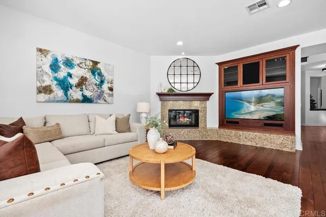 a kitchen with stainless steel appliances granite countertop wooden cabinets a sink and dishwasher with wooden floor