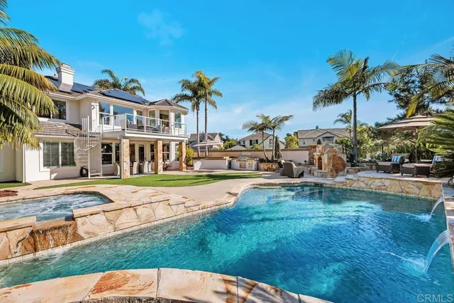 a view of backyard with swimming pool and patio