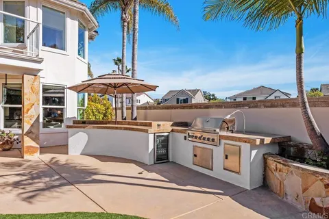 a view of a patio with couches table and chairs and potted plants