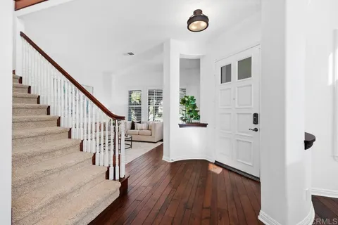 a living room with furniture a table and a large window