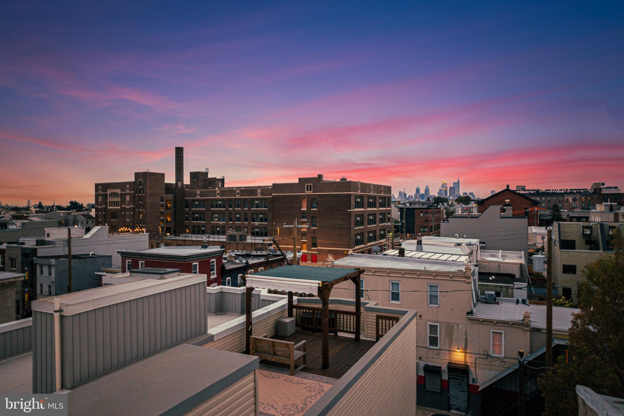 2041 East Sergeant Street Philadelphia, PA 19125 - Photo 36 of 40 Urban skyline at dusk with vibrant hues.
