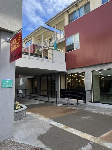 a view of a patio with couches table and chairs with wooden floor and fence