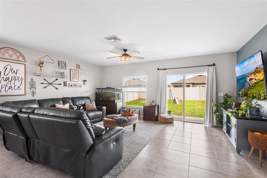 12960 Conquistador Loop Spring Hill, FL 34610 - Photo 11 of 26 a living room with furniture gym equipment and a large window