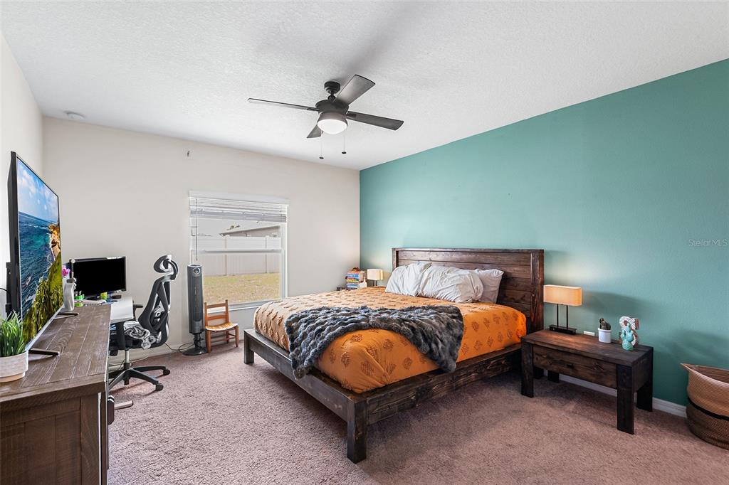 12960 Conquistador Loop Spring Hill, FL 34610 - Photo 14 of 26 a bed room with a bed furniture and a flat screen tv