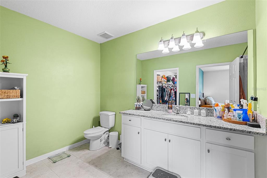 12960 Conquistador Loop Spring Hill, FL 34610 - Photo 15 of 26 a bathroom with a sink mirror and toilet