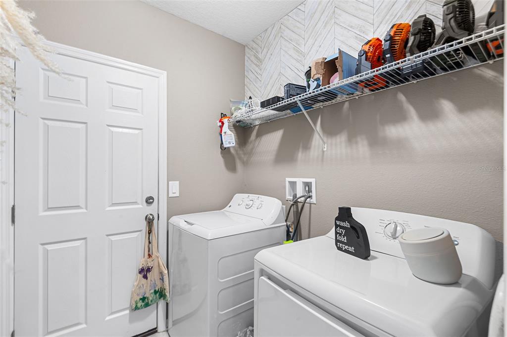 12960 Conquistador Loop Spring Hill, FL 34610 - Photo 18 of 26 a utility room with dryer and washer