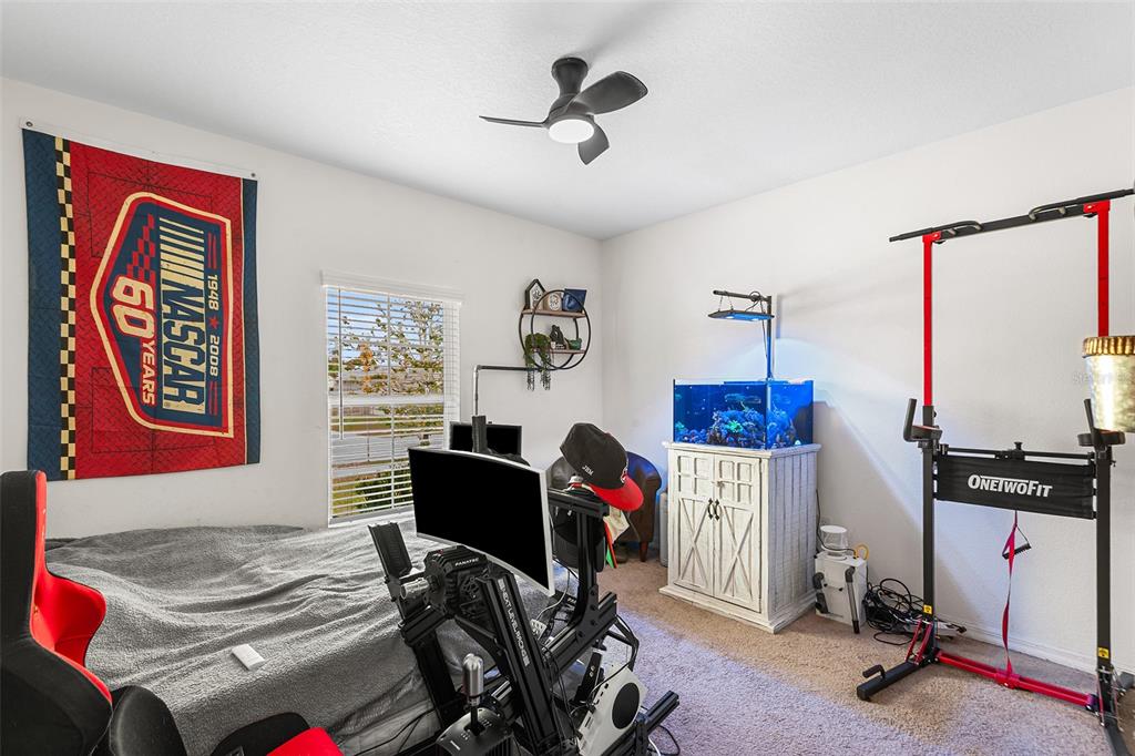 12960 Conquistador Loop Spring Hill, FL 34610 - Photo 19 of 26 a bedroom with furniture and a window