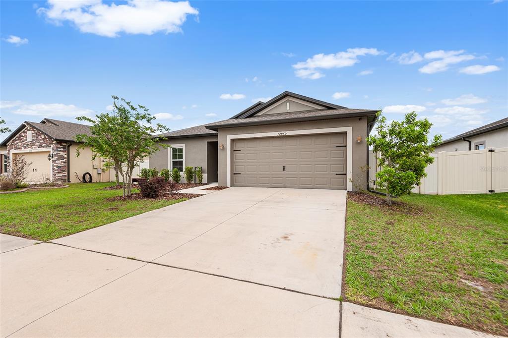 12960 Conquistador Loop Spring Hill, FL 34610 - Photo 2 of 26 a front view of house with yard