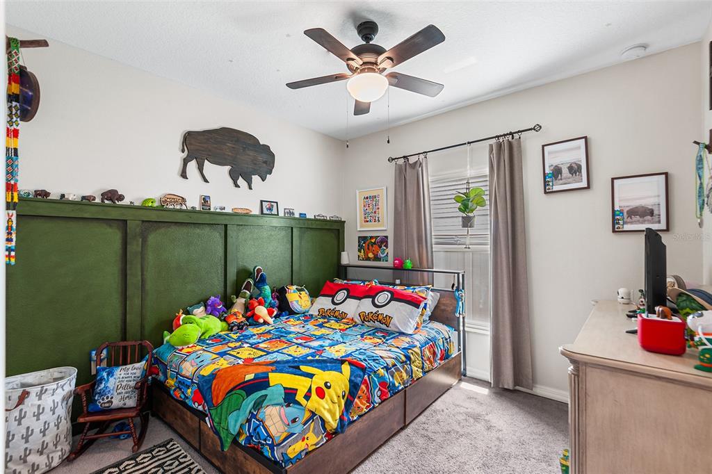12960 Conquistador Loop Spring Hill, FL 34610 - Photo 22 of 26 a bedroom with a bed and a workspace