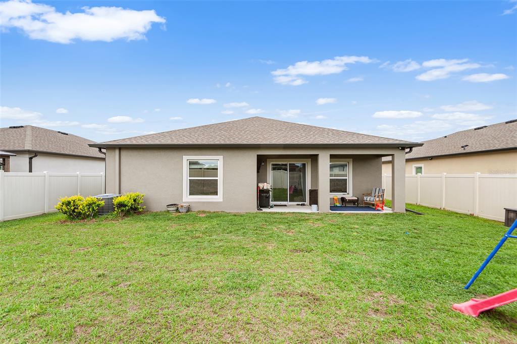 12960 Conquistador Loop Spring Hill, FL 34610 - Photo 25 of 26 a view of a house with backyard and garden