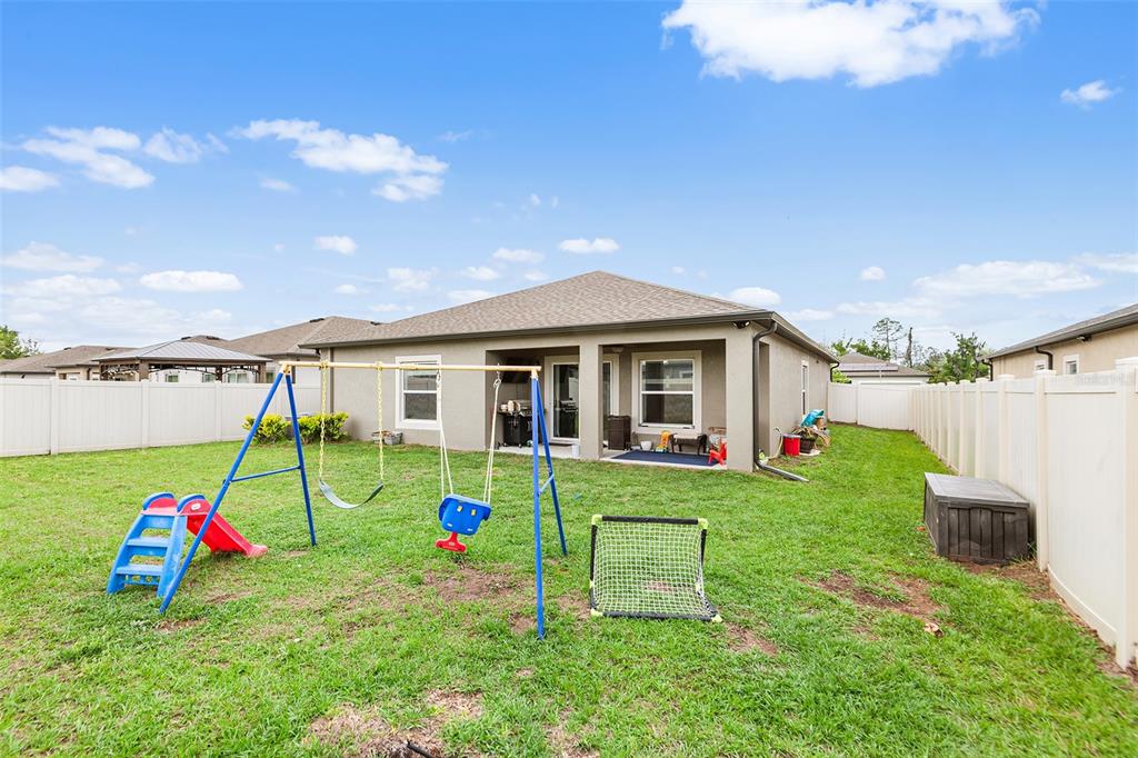 12960 Conquistador Loop Spring Hill, FL 34610 - Photo 26 of 26 a view of a house with backyard and sitting area