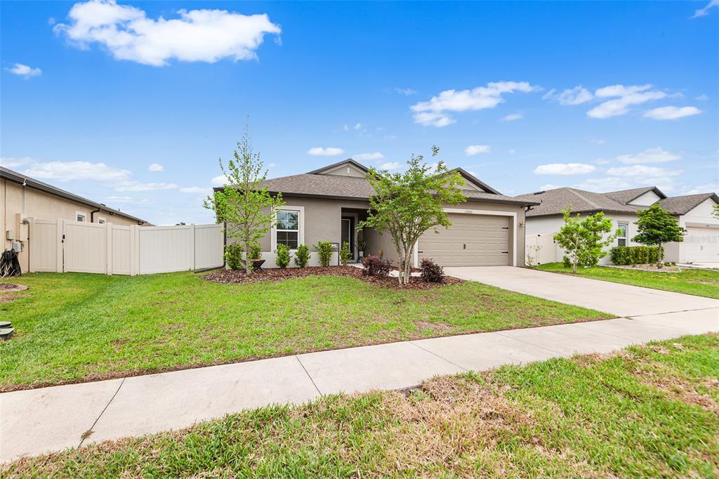 12960 Conquistador Loop Spring Hill, FL 34610 - Photo 3 of 26 a front view of a house with garden