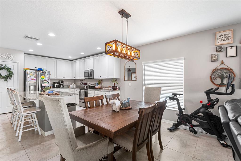 12960 Conquistador Loop Spring Hill, FL 34610 - Photo 9 of 26 a view of a dining room with furniture window and wooden floor
