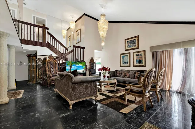 a living room with furniture and a chandelier