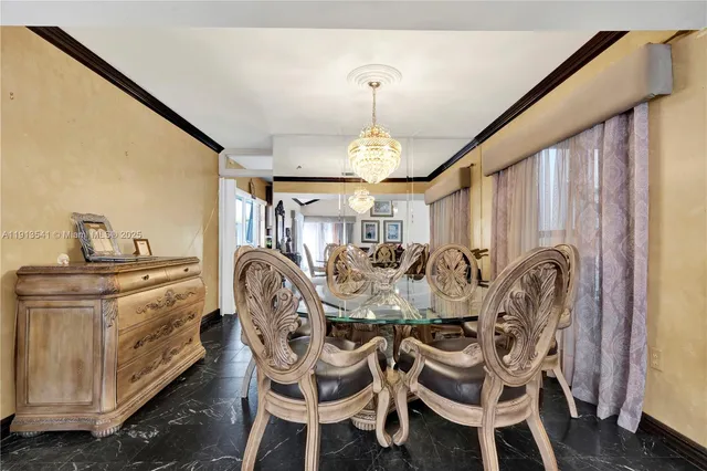 a living room with lots of furniture and a chandelier