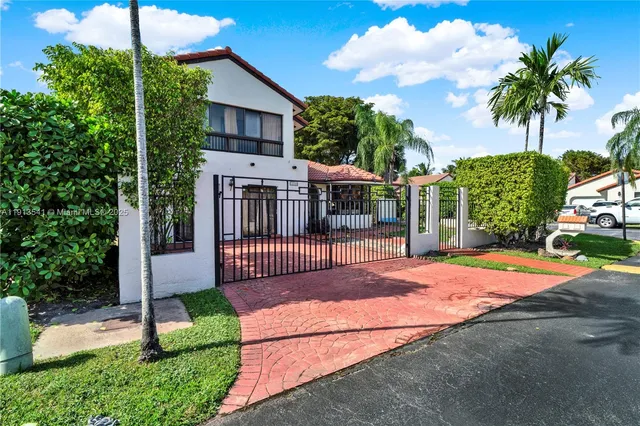 a view of a backyard with a deck and a garden