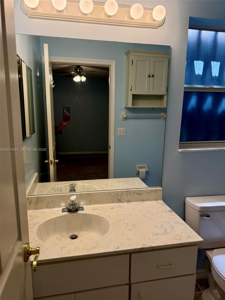 15819 76th Road North Loxahatchee, FL 33470 - Photo 36 of 45 a bathroom with a sink and a mirror