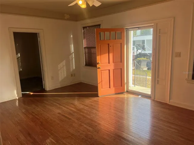a view of a hallway with wooden floor