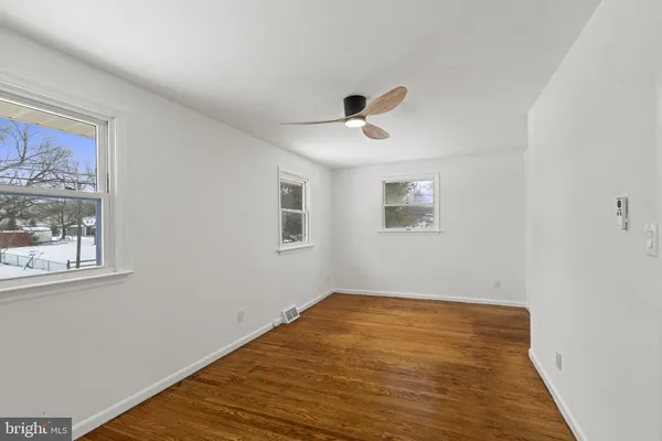 a view of empty room with wooden floor