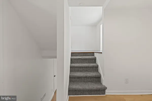 a view of staircase with white walls