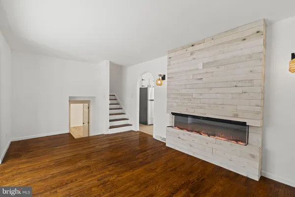 a view of an empty room with a fireplace