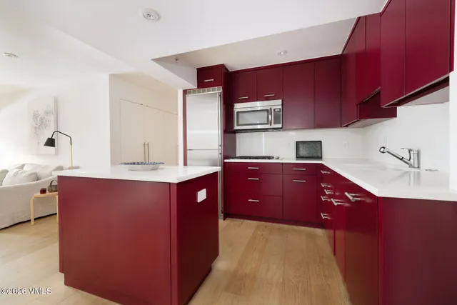 a kitchen with stainless steel appliances wooden cabinets and a sink