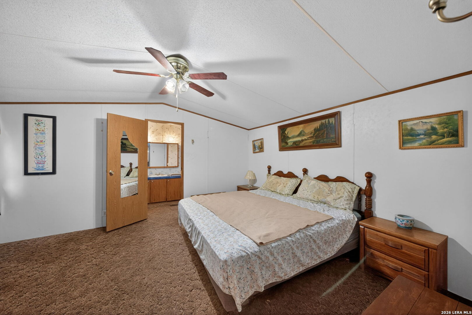 23398 Mathis Road Elmendorf, TX 78112 - Photo 9 of 18 a bedroom with a bed and a chandelier