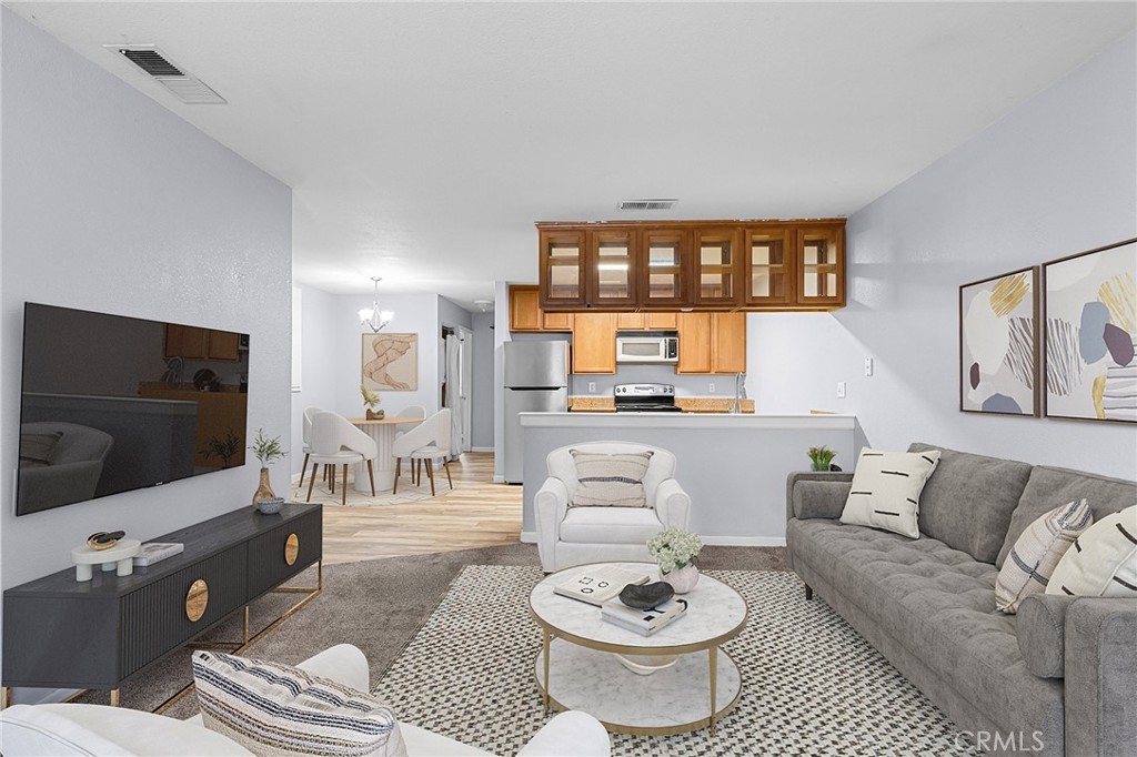 1114 Nord Avenue, Unit 11 Chico, CA 95926 - Photo 1 of 47 a living room with furniture and a flat screen tv