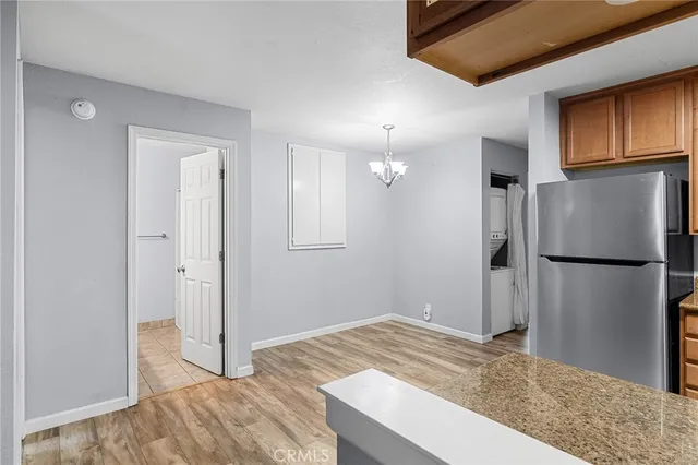 a kitchen with granite countertop stainless steel appliances a refrigerator stove and microwave