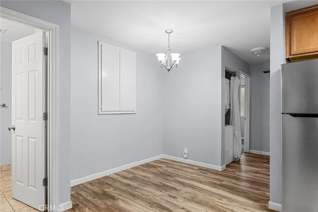 a utility room with stainless steel appliances granite countertop a sink and dishwasher