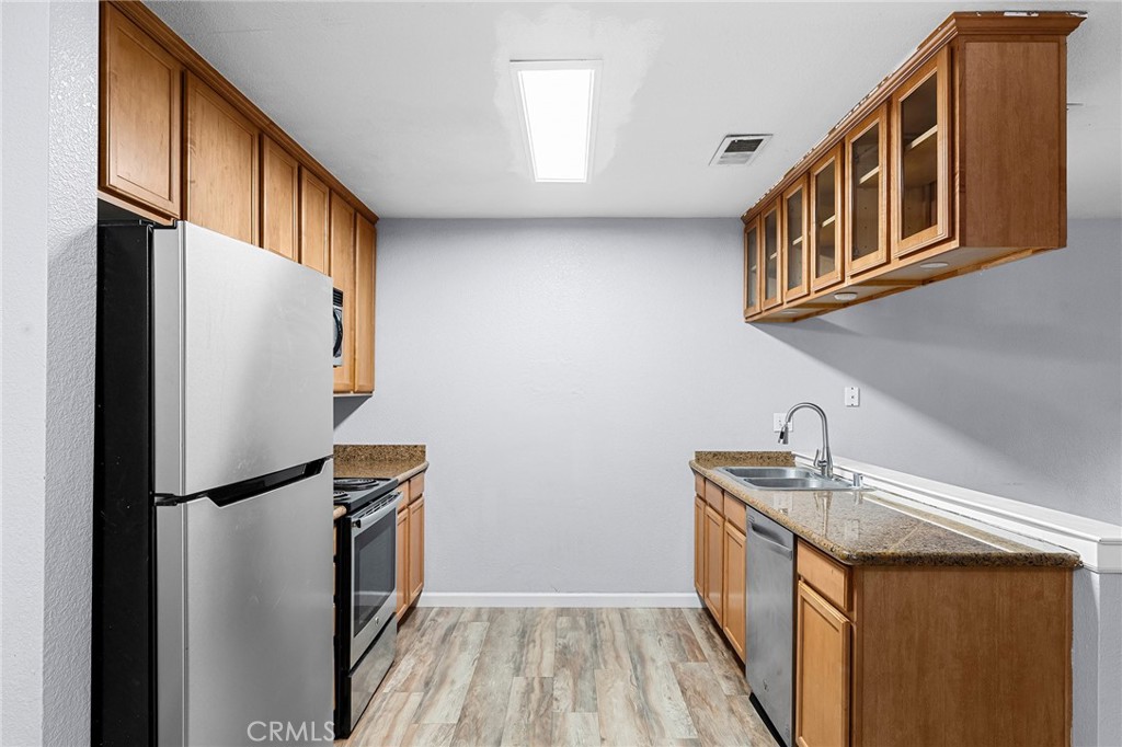 1114 Nord Avenue, Unit 11 Chico, CA 95926 - Photo 27 of 47 a kitchen with a refrigerator a sink and dishwasher
