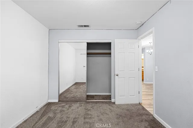 a bathroom with a granite countertop sink a mirror and shower