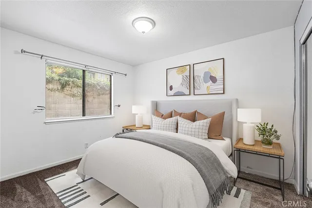 a bedroom with bed and window