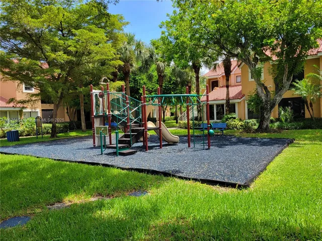 a view of a park with swings and slides