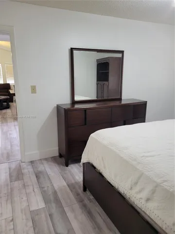 a bedroom with a bed and a mirror
